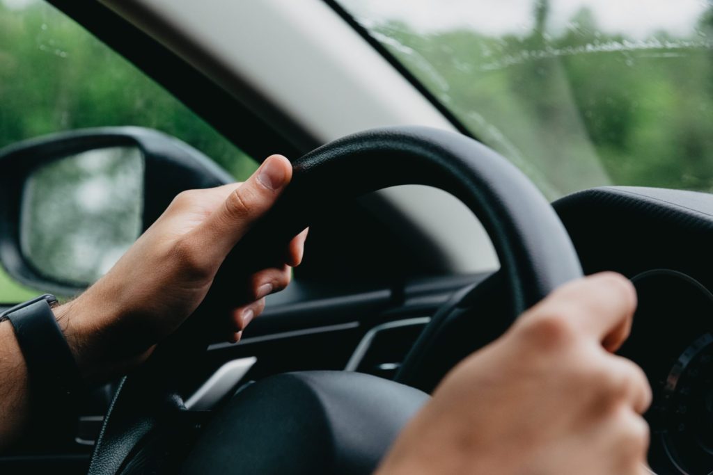 Man hands on steering wheel