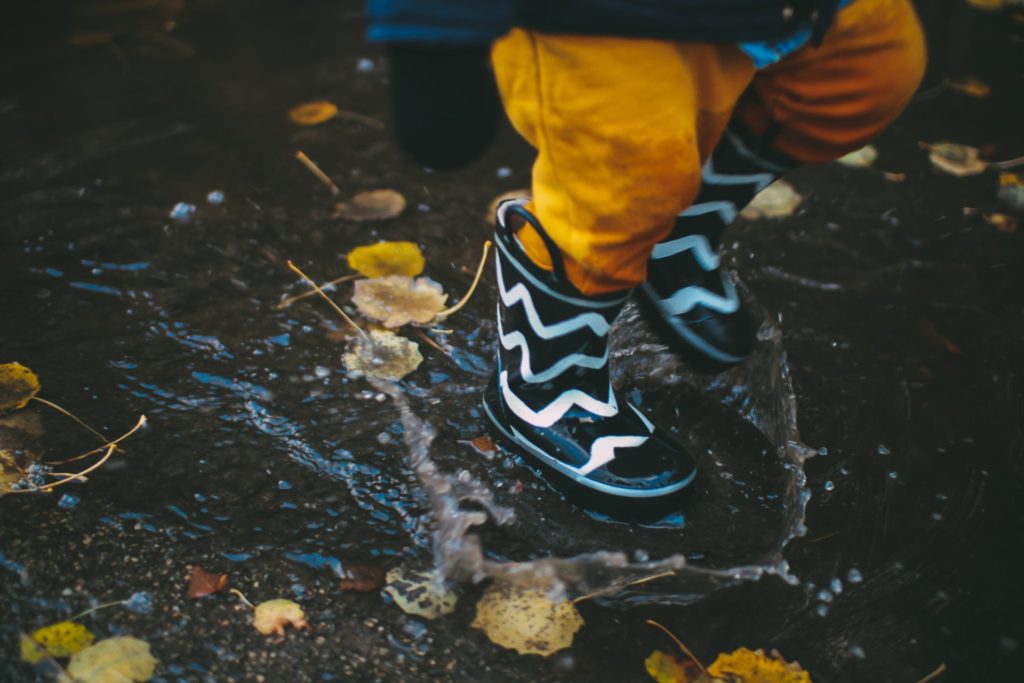 Child splashing in a puddle