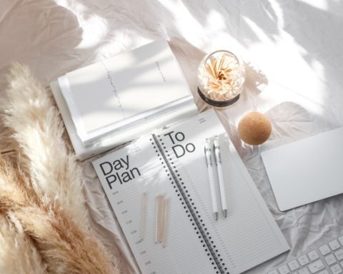 Planner with stationery on bed