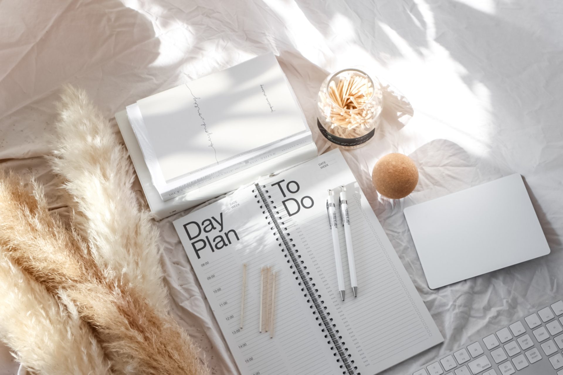 Planner with stationery on bed