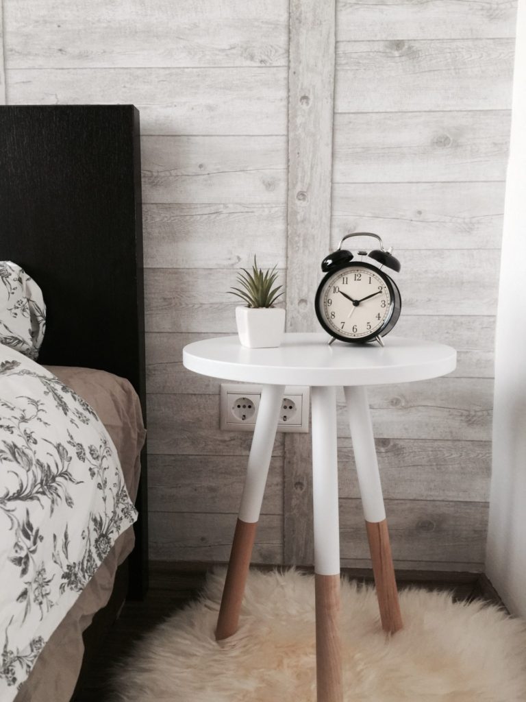 Bed, bedside table with clock