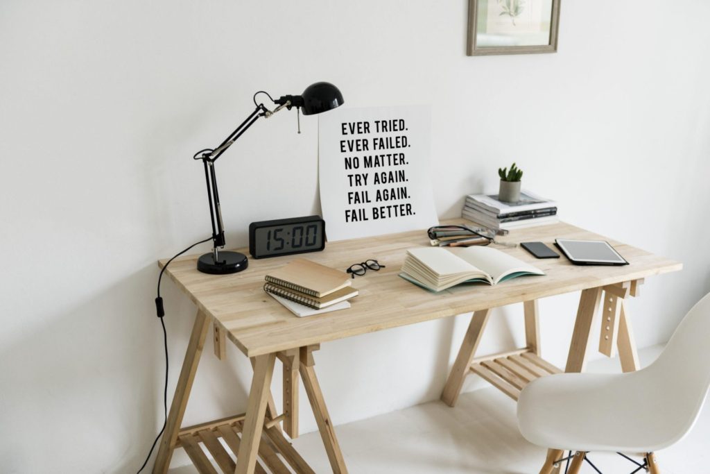 Desk with lamp, notebooks and stationery