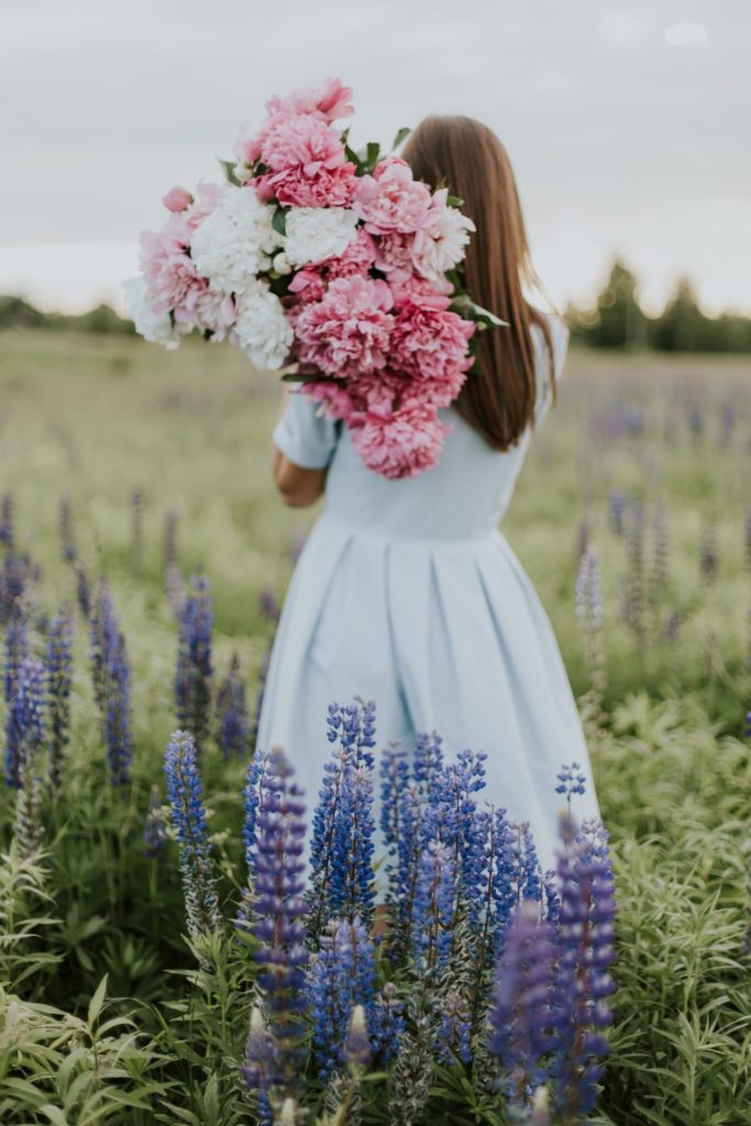 Woman in field with flowers