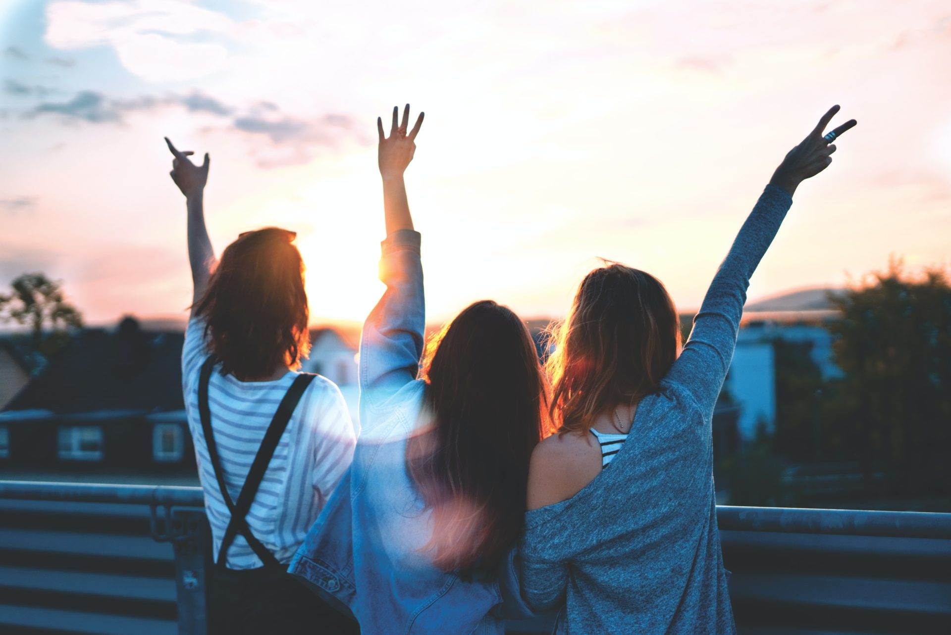 3 Women with Hands in the Air