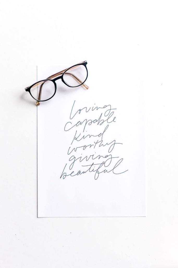 Paper with written words next to spectacles