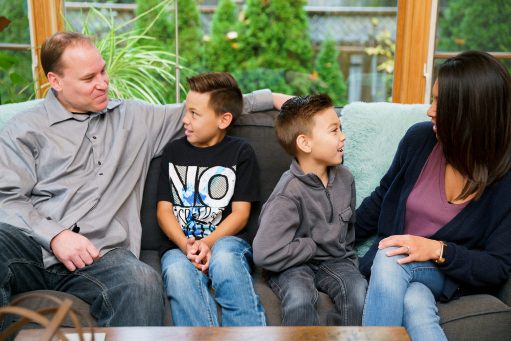 famiy-sitting-on-couch