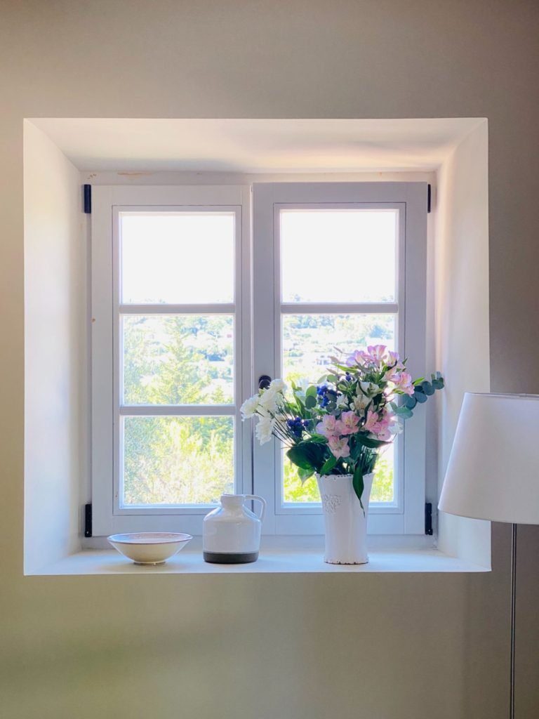 Vase with flowers on a windowsill