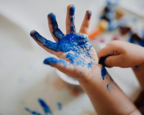 Child's hand with blue paint