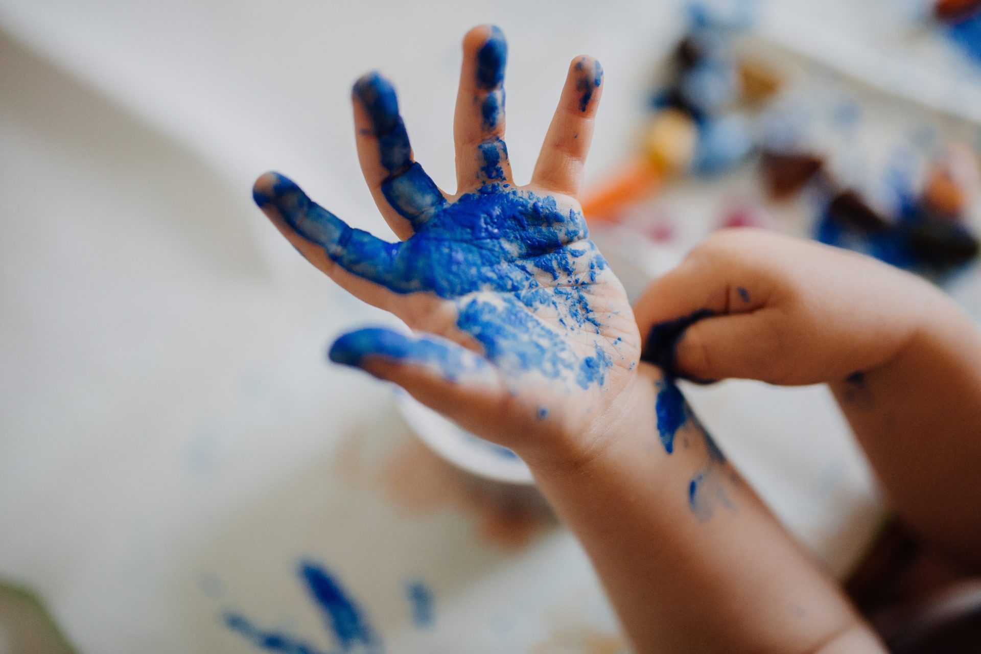 Child's hand with blue paint
