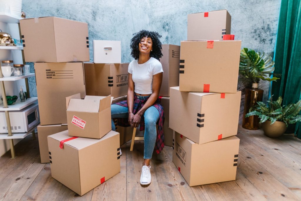 Woman sitting on moving boxes
