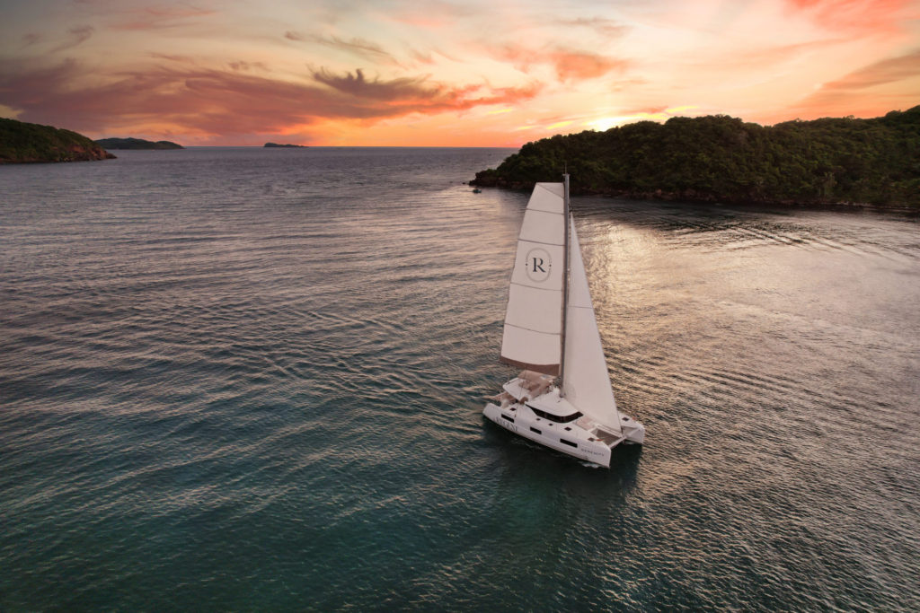 A Sailboat out at sea at sunset