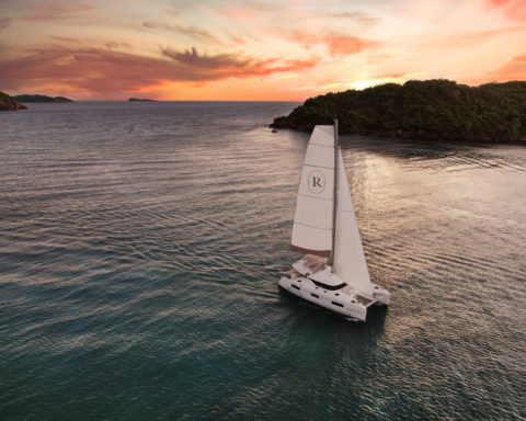 A Sailboat out at sea at sunset