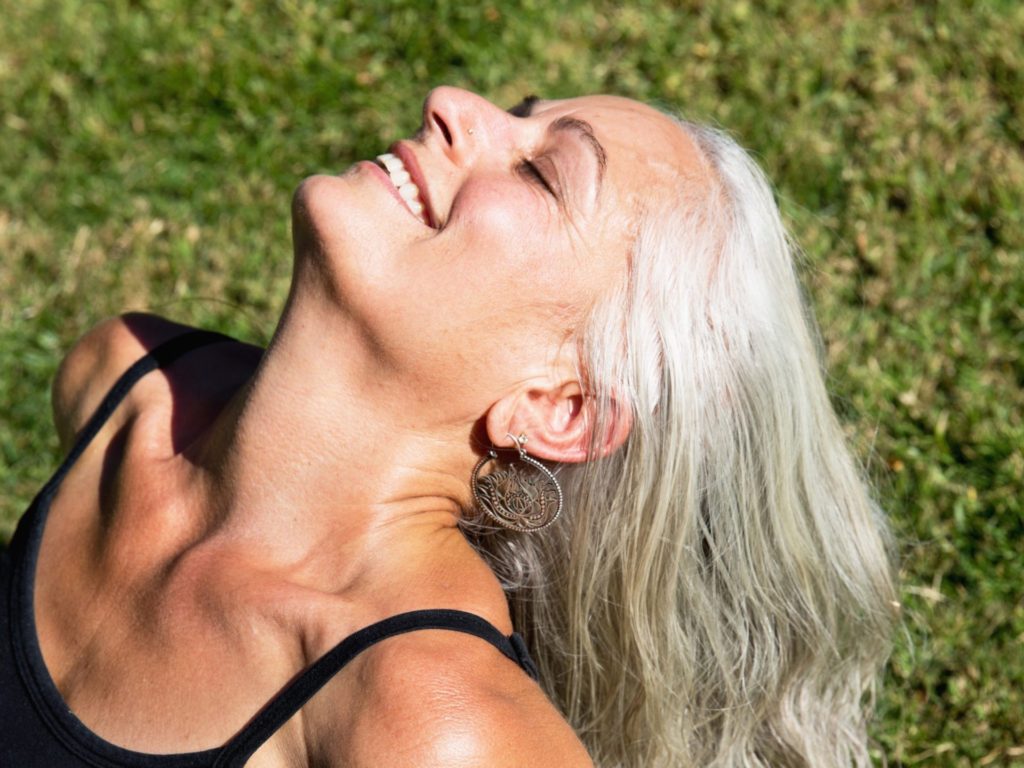 A smiling woman with grey hair